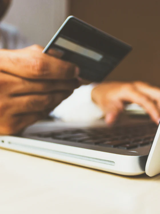 Shopper entering card details on a laptop to complete an online order