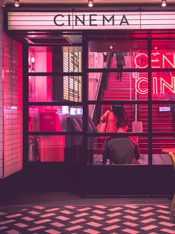 Cinema entrance lit by neon signage